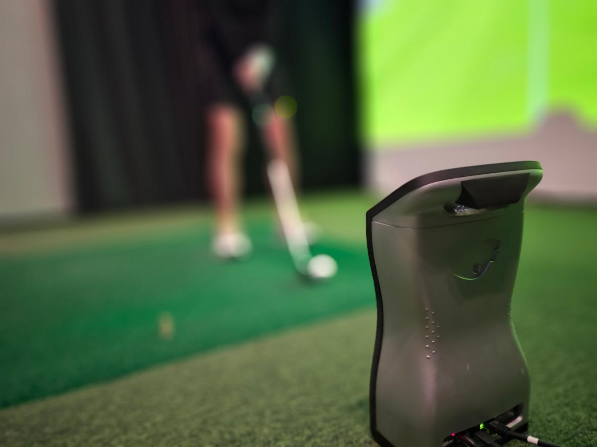 Indoor golf training setup with a focus on swing analysis and performance improvement in a controlled environment