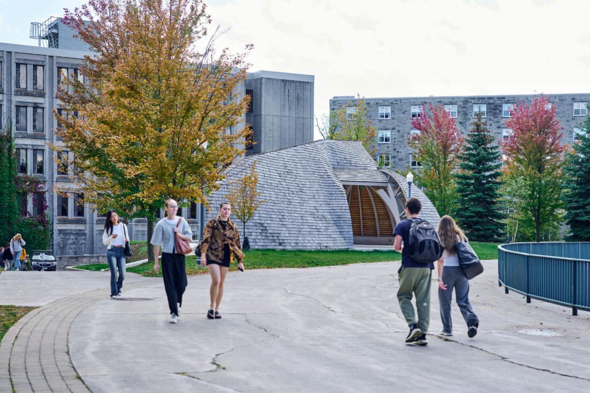 Students walk by the Outdoor Indigenous Gathering Space in the fall