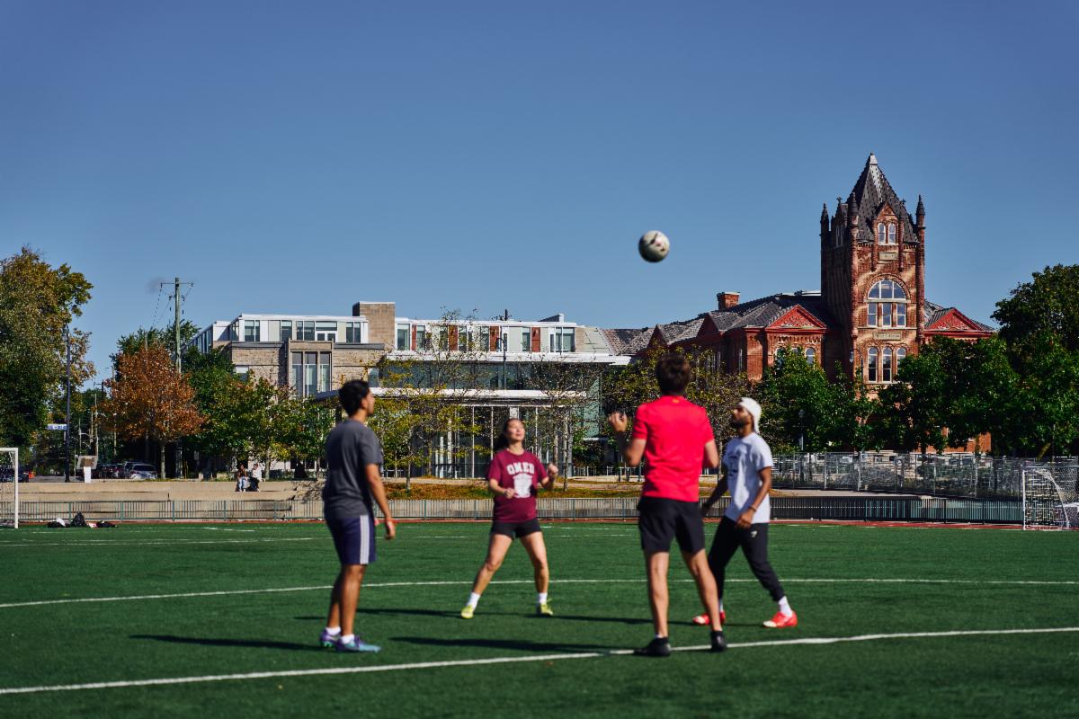 Students playing with a sports ball on Tindall Field