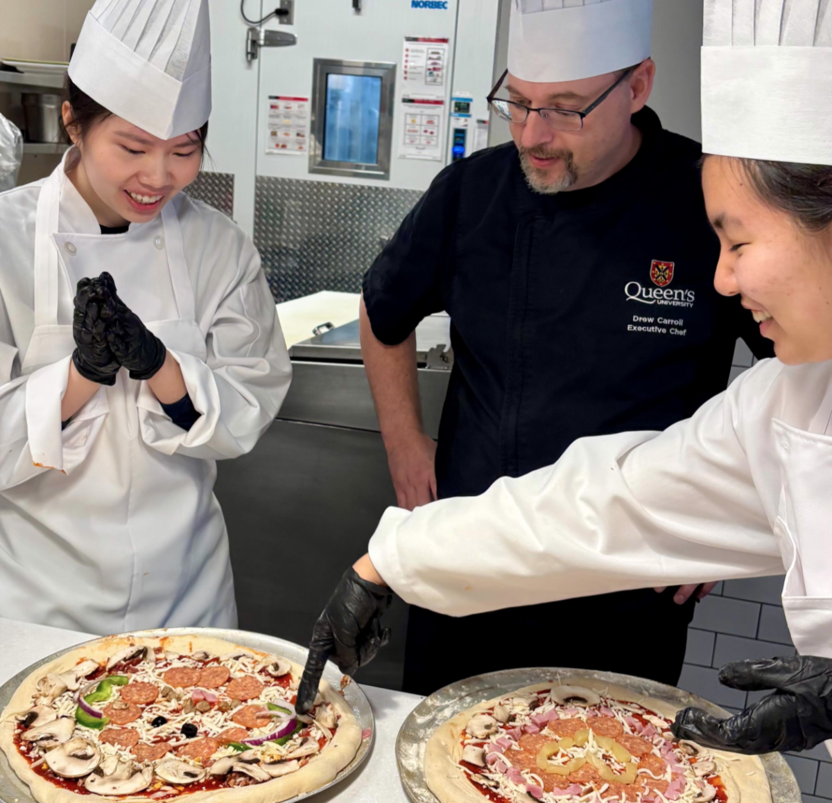Two students attend a pizza cooking class
