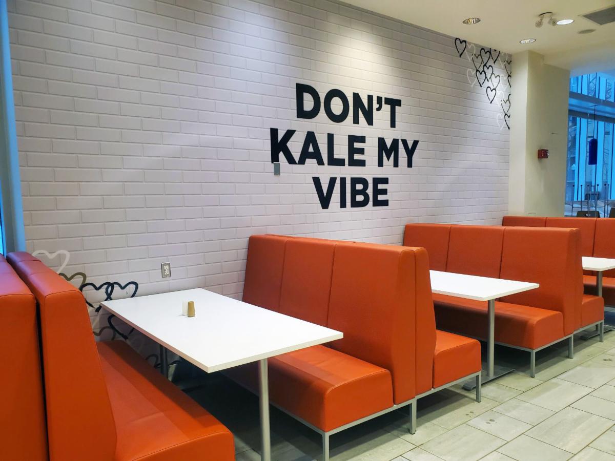 Booths in Leonard Hall with large sign that reads, "Don't kale my vibe"