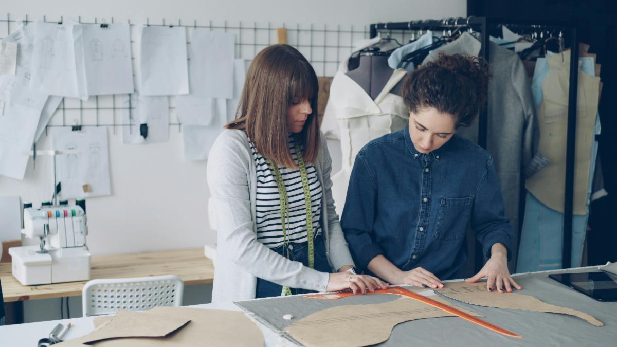 Two people working together in a sewing workshop room