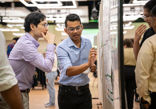 Students discussing poster at University Research Day