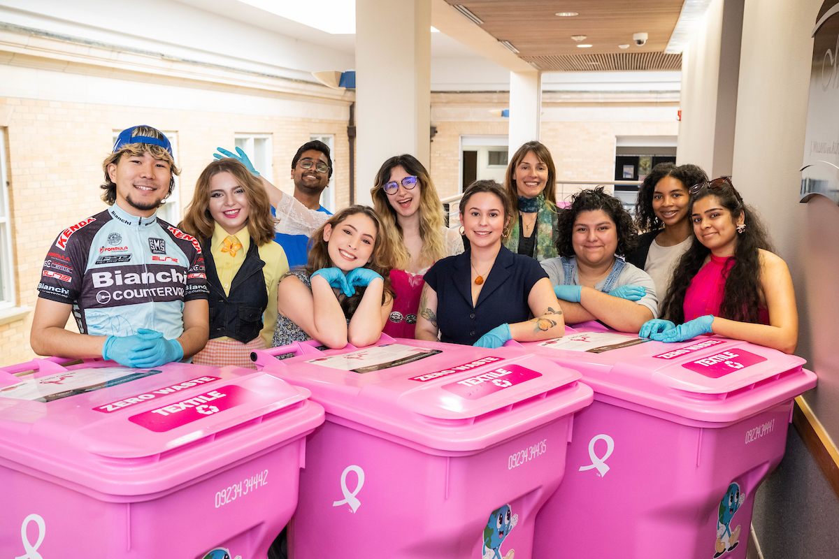 Iva Jestratijevic and her class pose with textile recycling bins