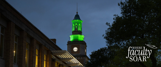 McConnell Tower lit green against a dark blue sky