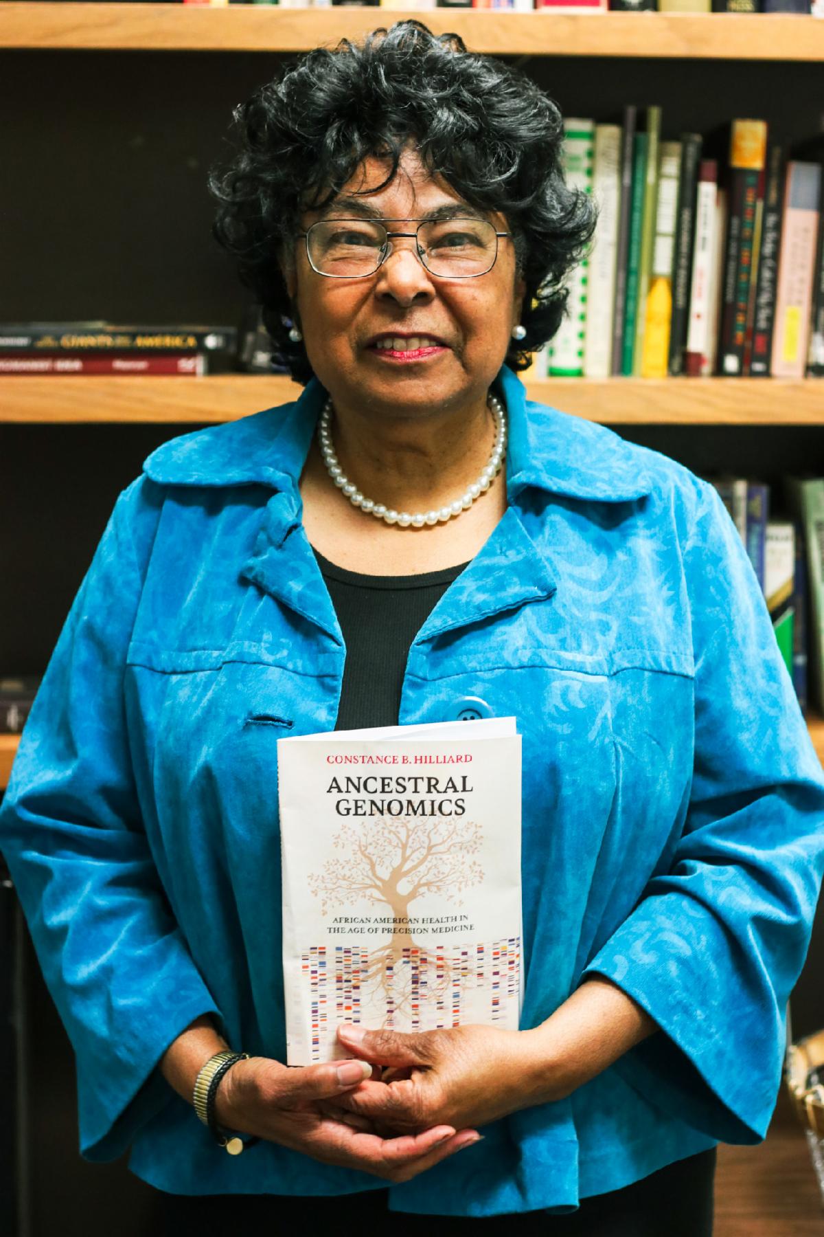 Constance Hilliard poses with her new book Ancestral Genomics