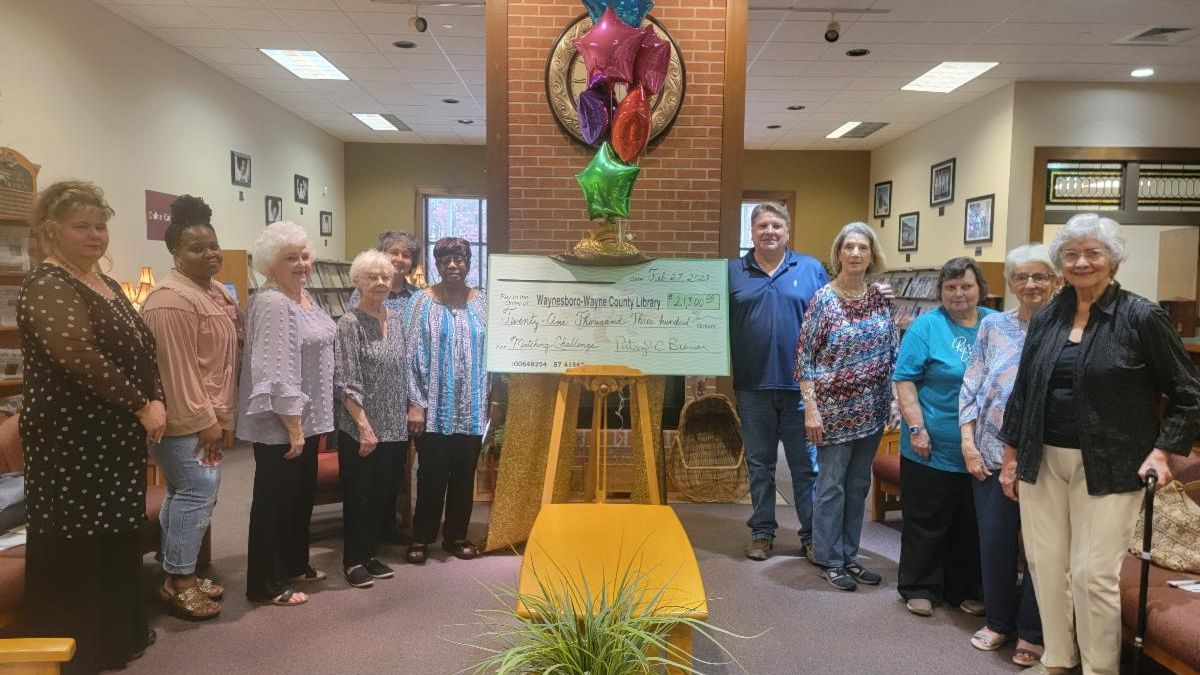 Photo of library staff with donation check. Photo by Waynesboro-Wayne County Library.