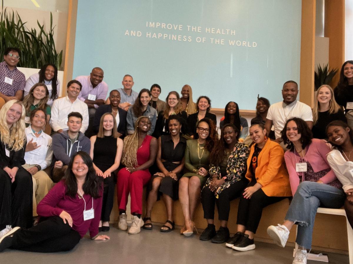 CEO Jeff Vanderploeg and board member Wizdom Powell pose in a large, diverse group of young people at the recent Headspace convening in California.