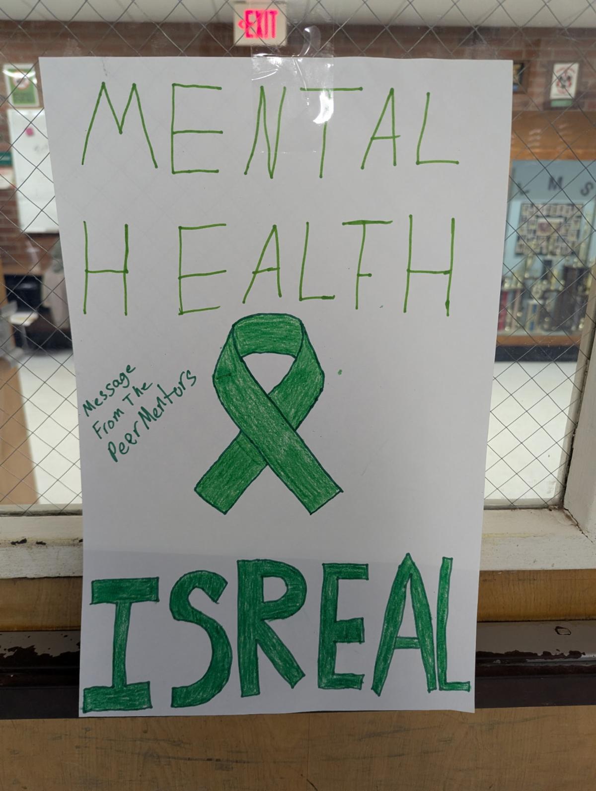 Poster created by student peer support team members reading "Mental Health is Real - a message from the peer mentors"