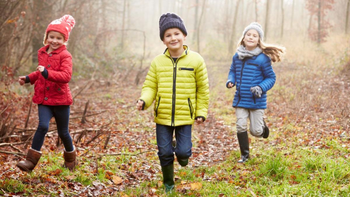 Kids running through leaves