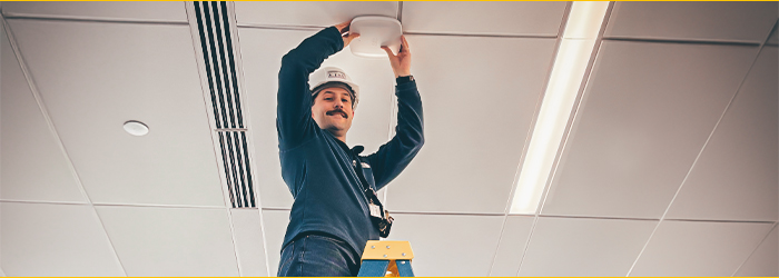 Photo of ITS employee installing APs in the new Academic Building.
