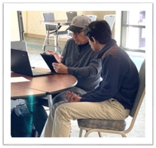 Tech-Y-Tutor student helping senior with technology