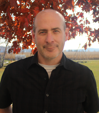 A man standing in front of a tree