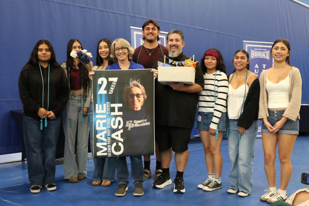 A group of students, staff, and faculty posing next to one another. 