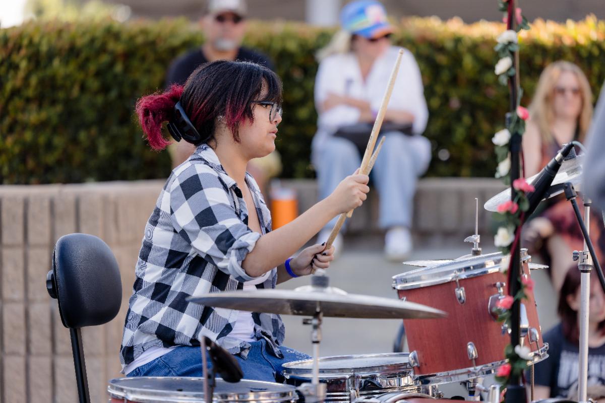 Student playing the drums as part of a performance