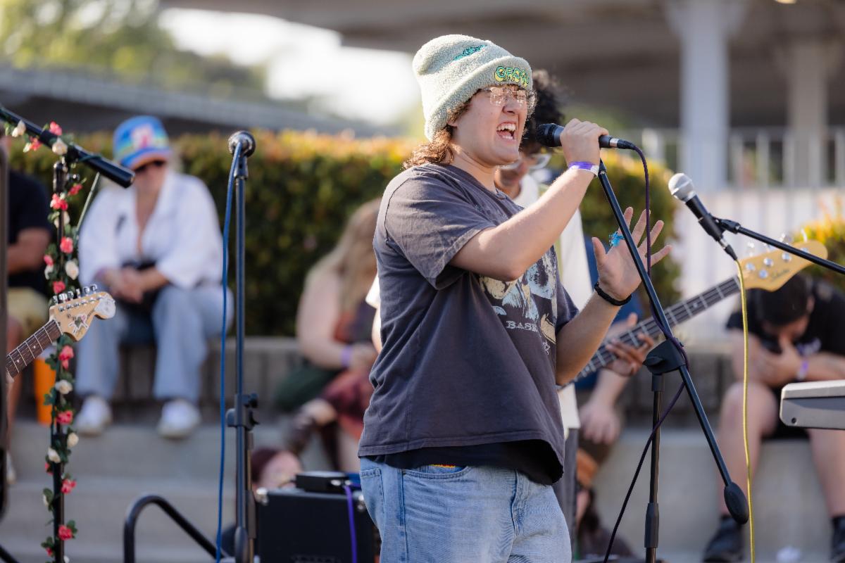 Student singing while performing with a band
