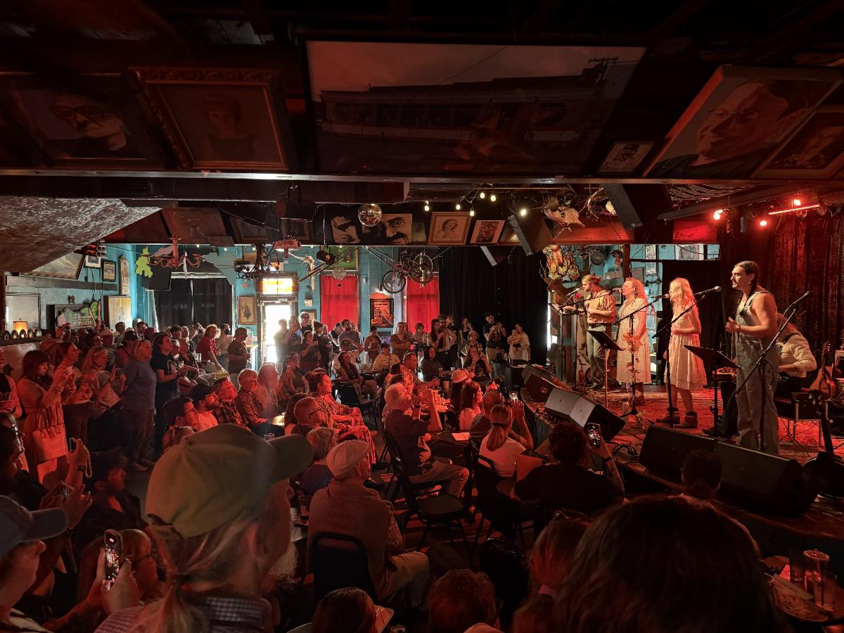 A full audience watches a performance raptly.
