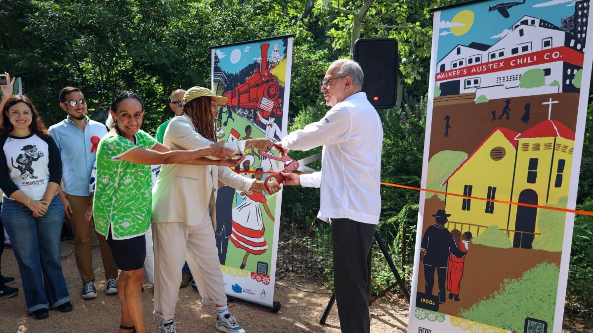 People participate in a ribbon cutting in the 5th Street Cultural District