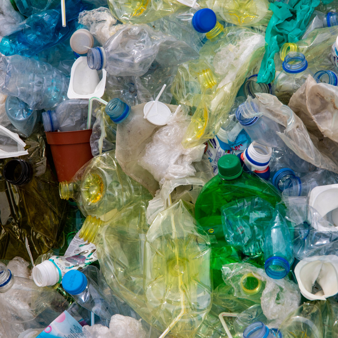 a close up look at an array of colorful single use plastic bottles