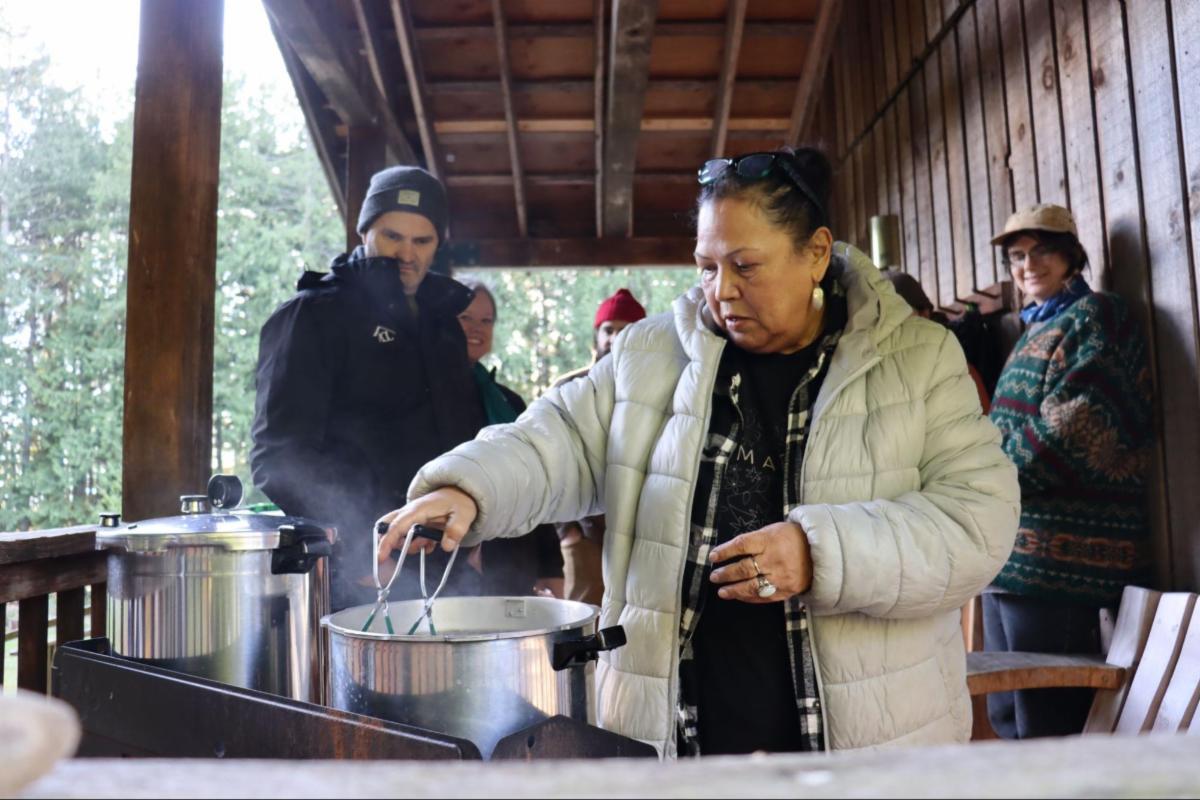 Rosemary Georgeson removes freshly canned smuyuth (venison) from a pressure cooker, by Adam Huggins