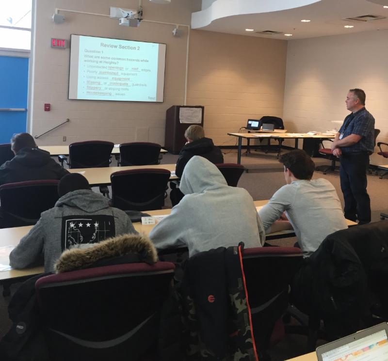 Students sitting in a conference room listening to a presentation