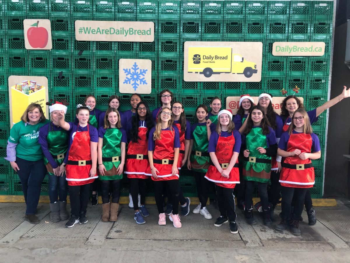 Group of female students and staff at the Daily Food bank in Toronto.