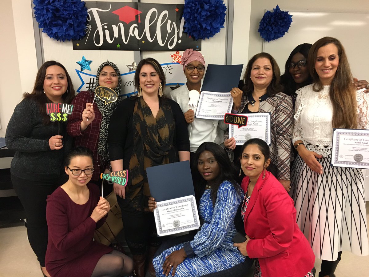 Ten female adults holding their certificates of completion.