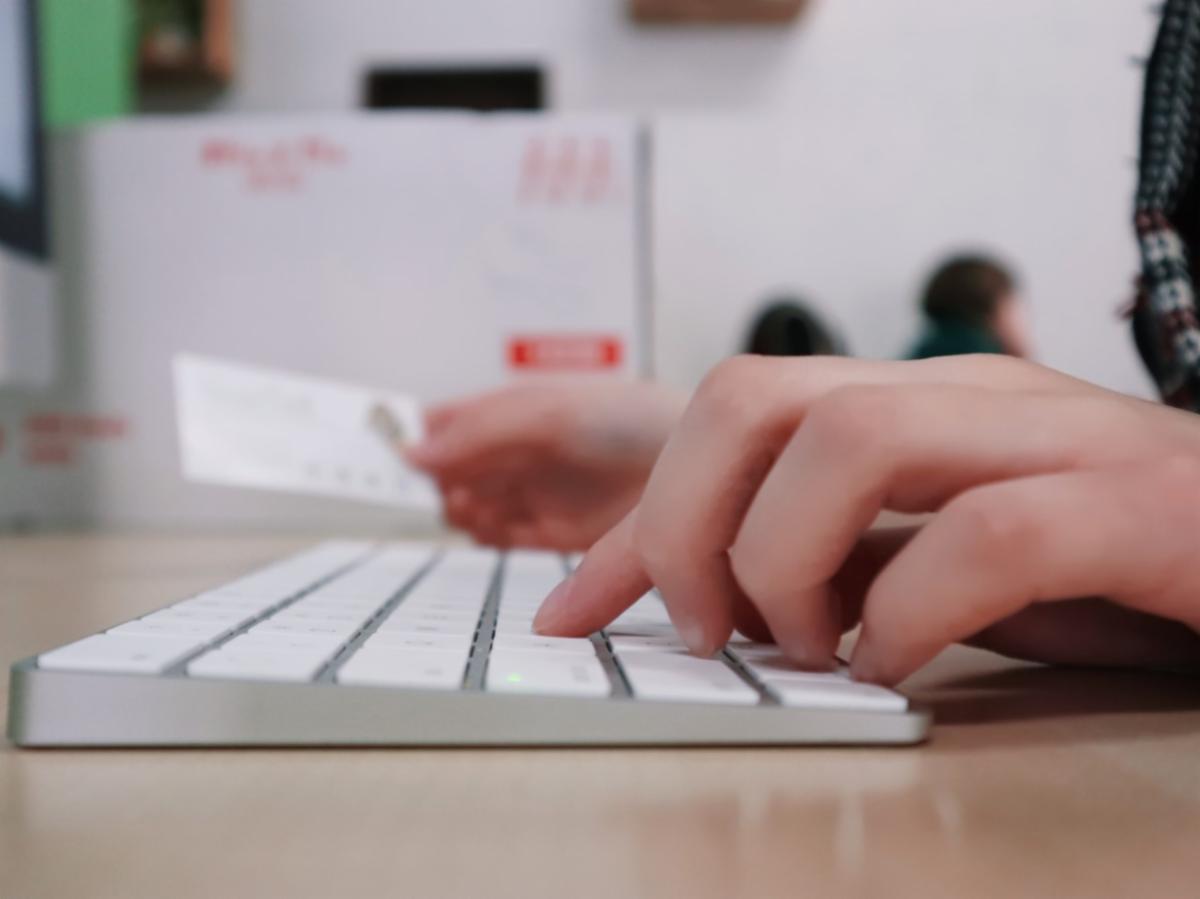 Hand working on a keyboard.
