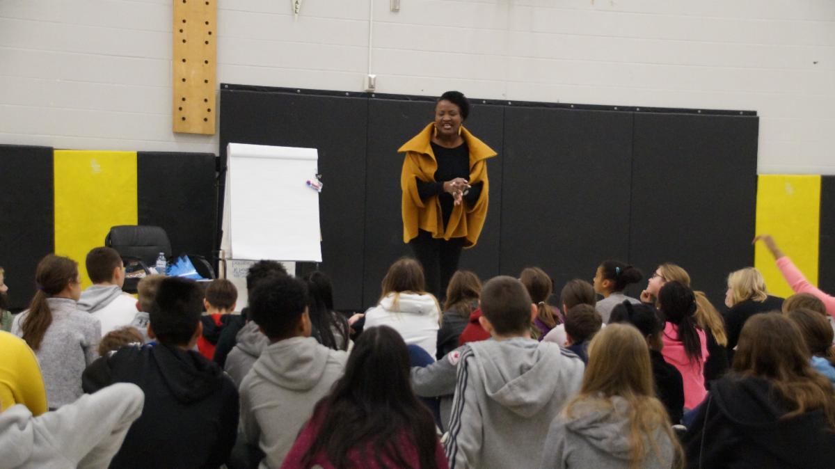 Female adult and poet shares her Black History poems with students.