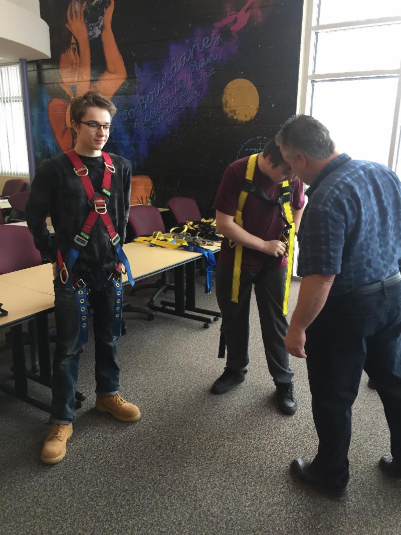 Students wearing safety harnesses for safety training