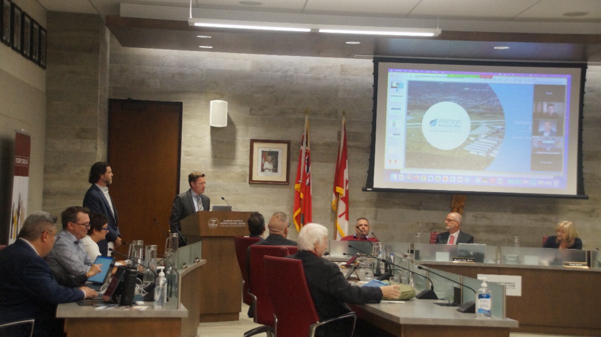 Two male adults presenting on the Oshawa Catholic School's data