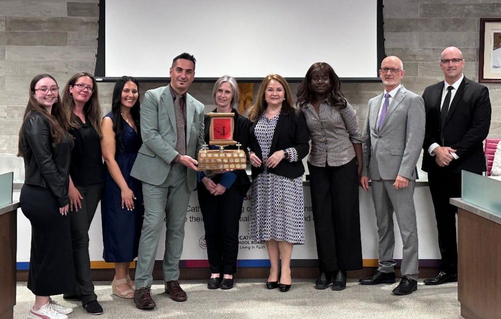 St. Bernadette school team receiving award from Chair Forster, with student Trustees, Trustee Ste. Marie and Director Winn