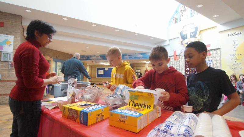 Three male students making their own healthy yogurt snack