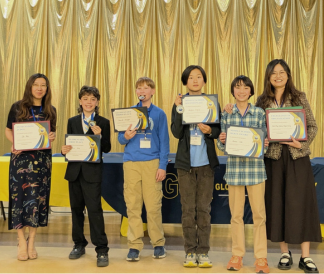 Four students and two teachers holding Chinese Bridge certificates