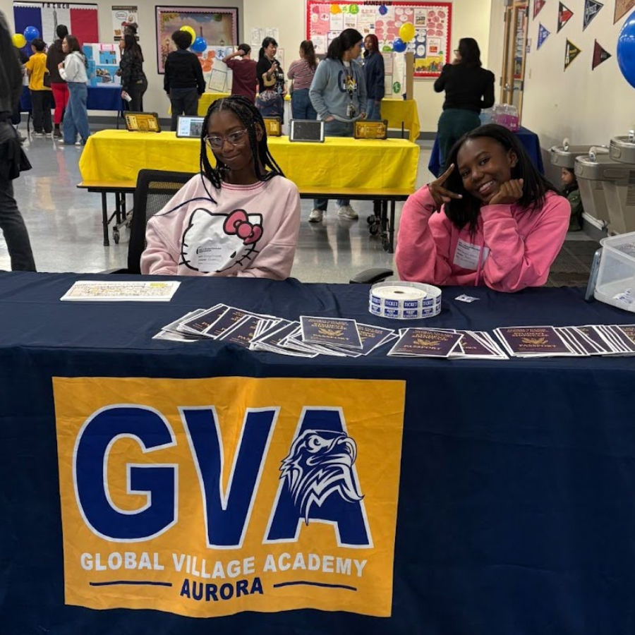 Two students sitting at the GVA Aurora table at the student showcase