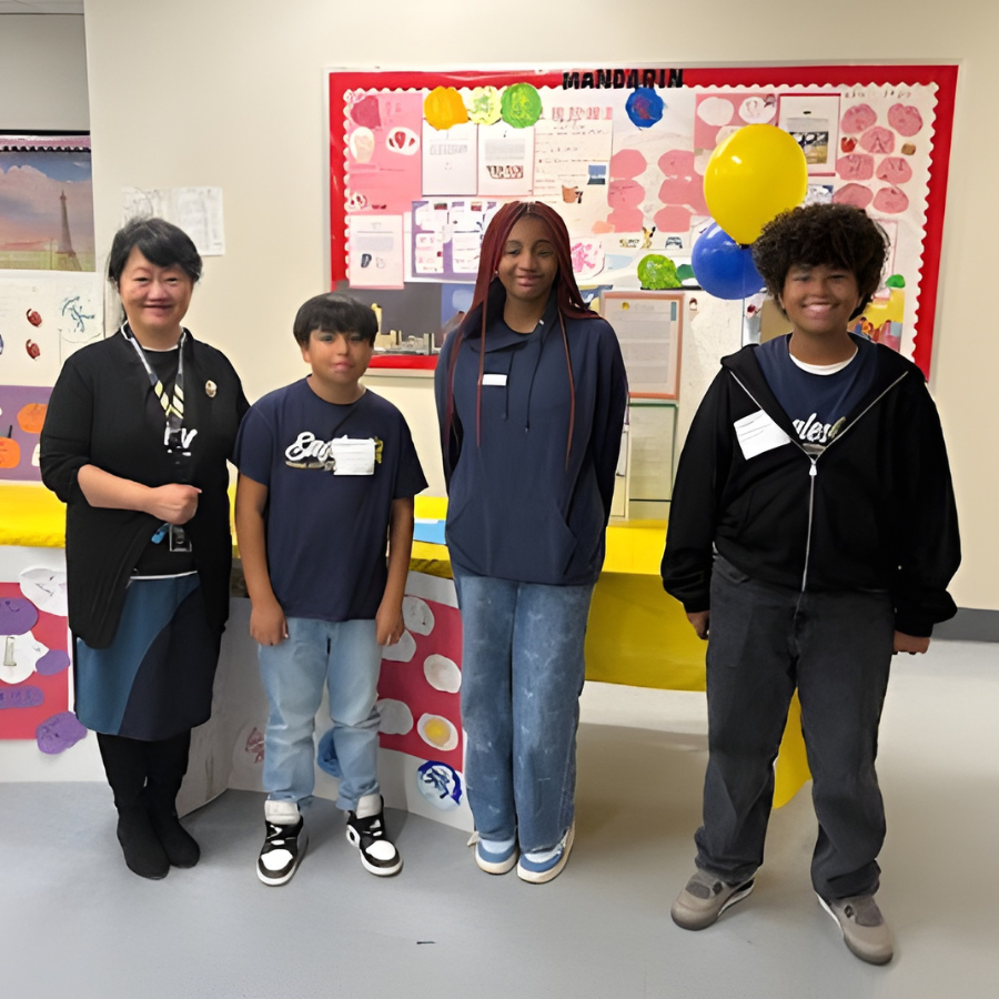 Three students and a teacher at the Student Showcase