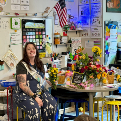 Alexa Valdez in classroom with table full of gifts