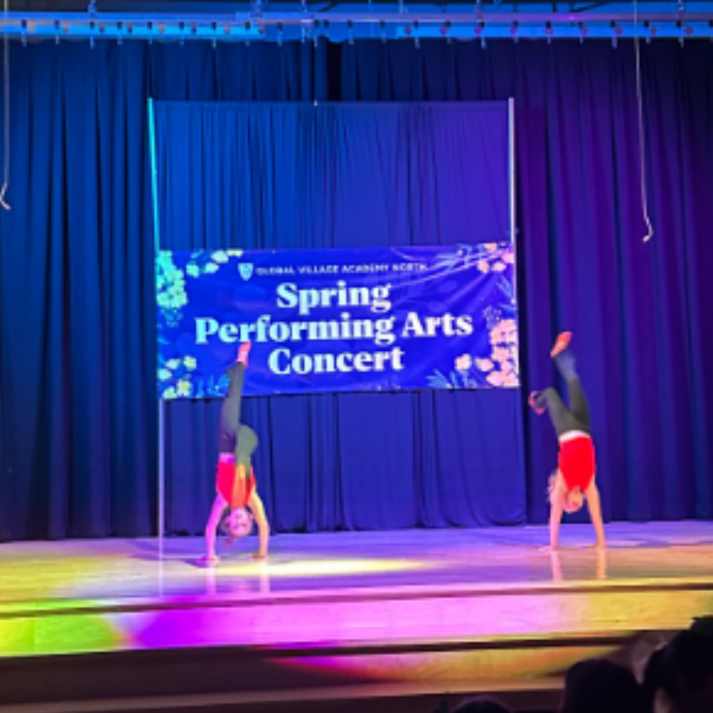 Two students during handstands on stage at spring performance