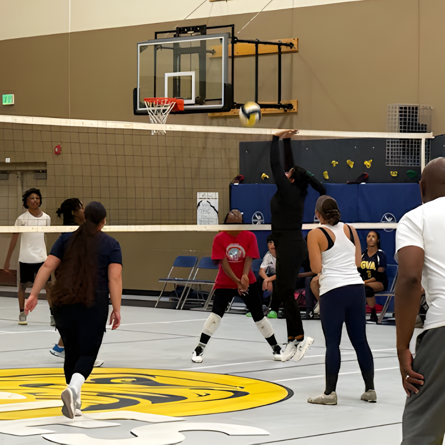 students vs staff playing volleyball game