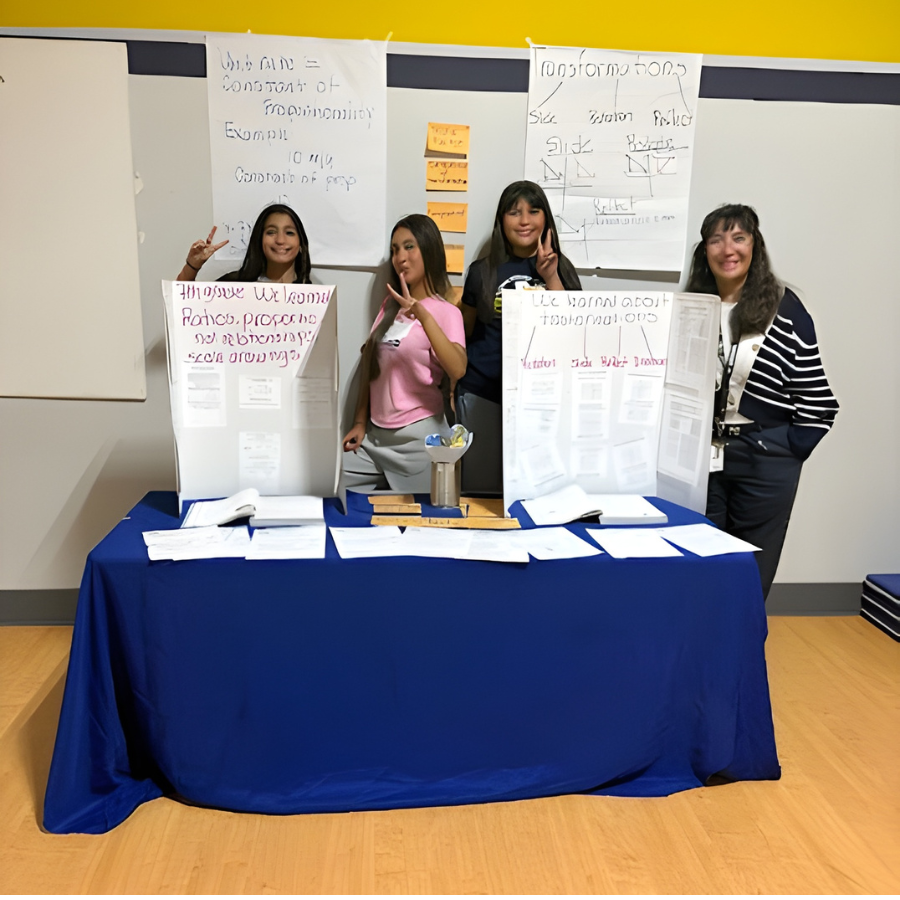 Three students and a teacher presenting a showcase