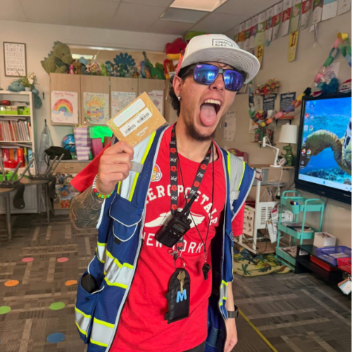 Teacher making silly face while posing with a gift card