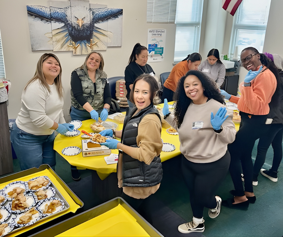 Staff around a table with slices of pie