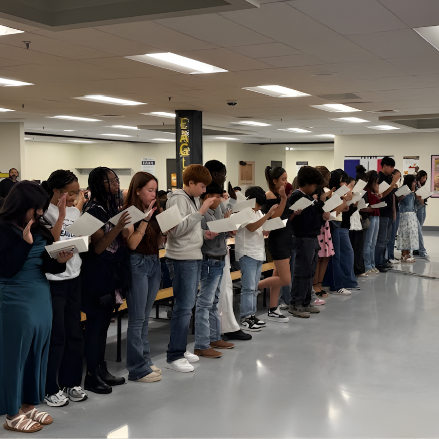 Students in line reading from NJHS award notes