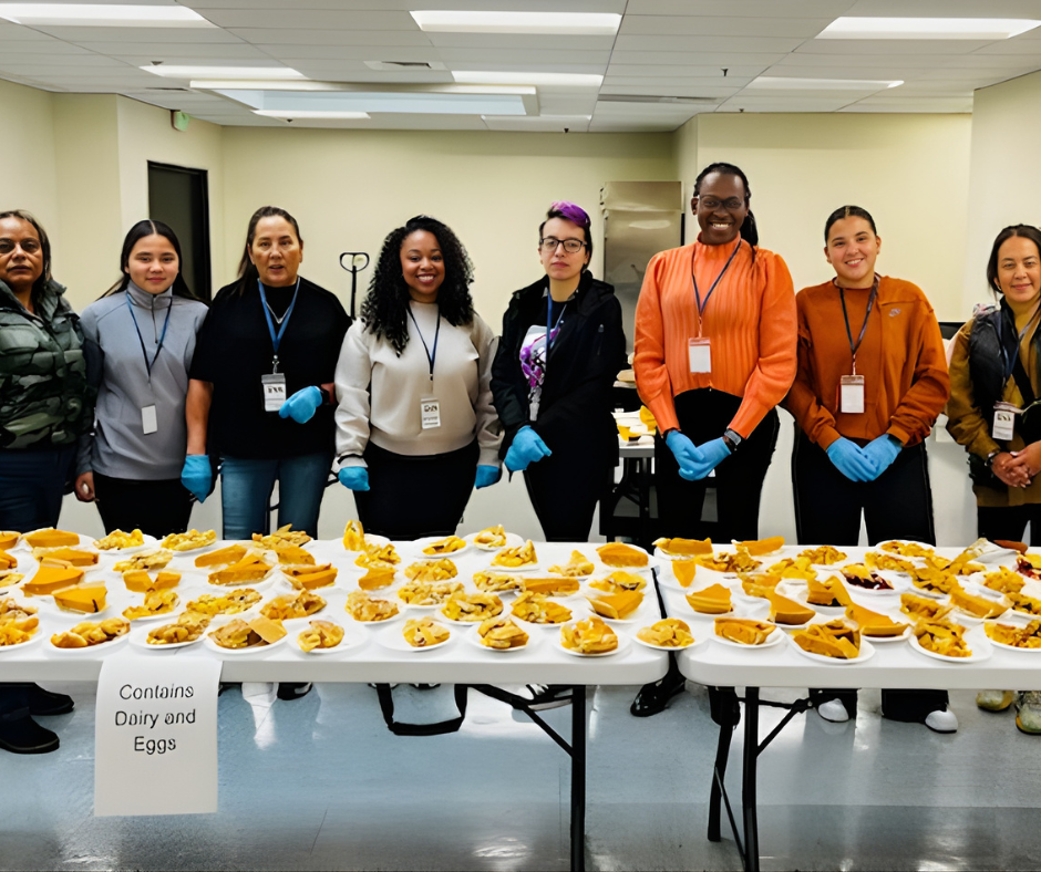 GVA staff members standing behind folding tables filled with slices of pie