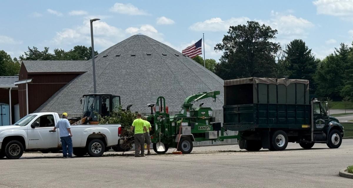 maintenance crew loading brush into chipper