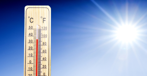 Thermometer in summer day shows or indicate high temperature degree with sun in background. 