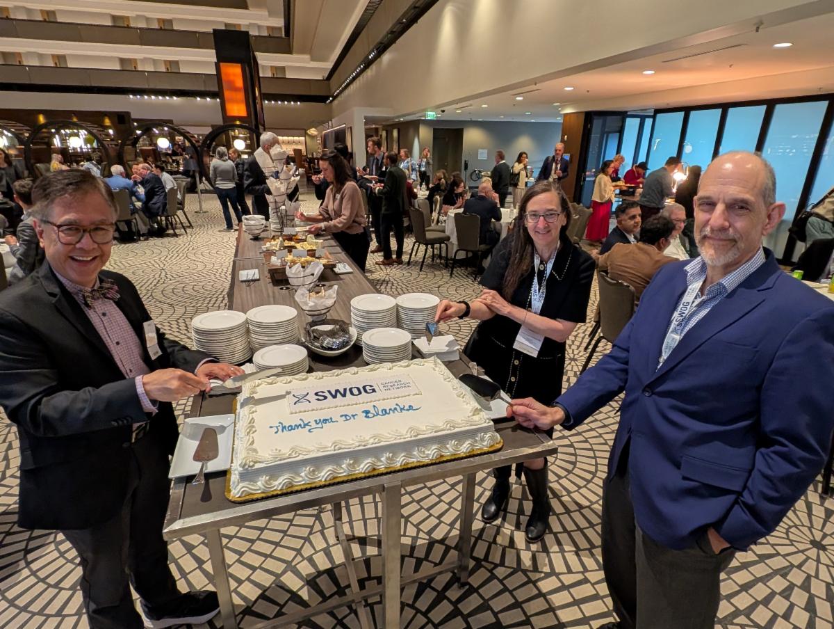 Drs. Hershman, Lara, and Blanke poised to cut the cake at spring group meeting