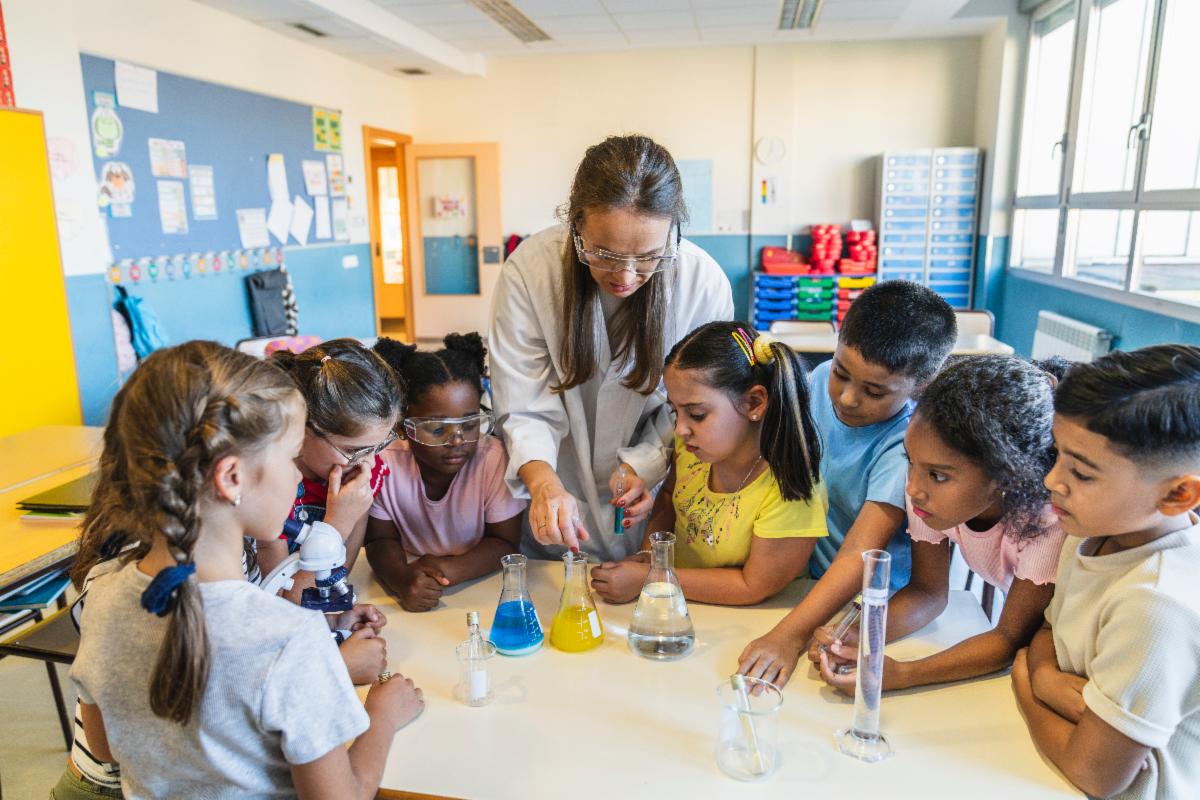 Children learning science from a teacher in a classroom