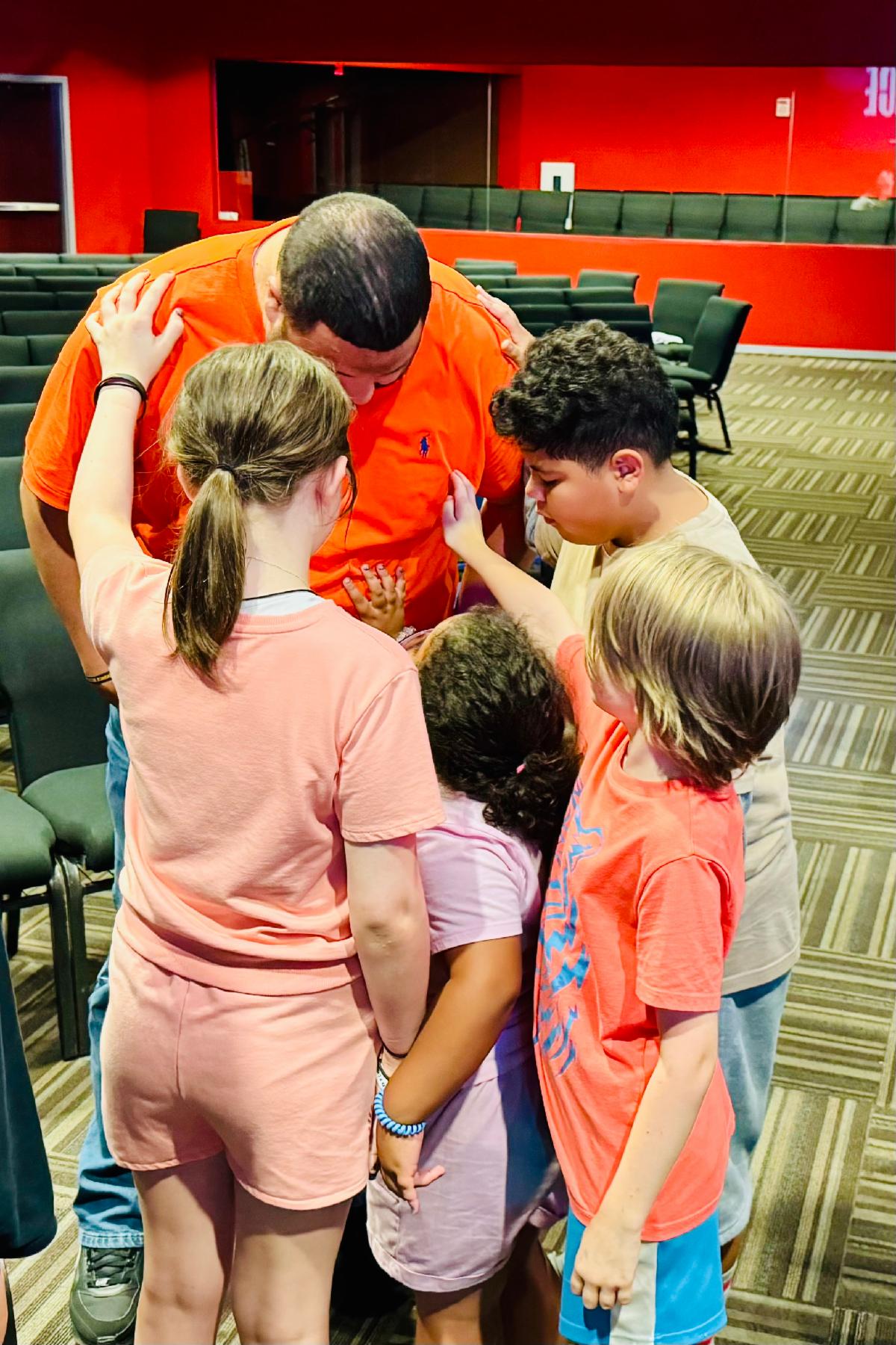 Kids praying over Christian Abrahamson