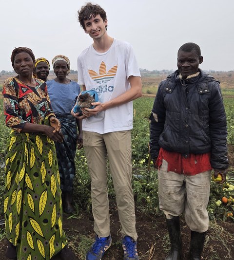 Cyrus Aryani in Malawi with members of the Chivunguti Irrigation Club in their tomato field